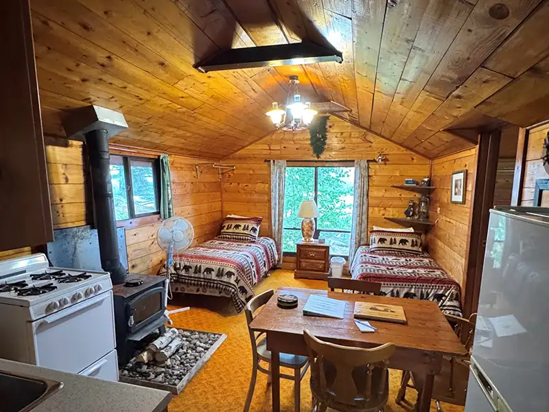 Cabin Accommodations at Grassy Narrows Lodge Cozy cabin interior with wood finishes and comfortable accommodations at Grassy Narrows Lodge.