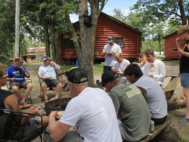 Family Fishing Vacation at Grassy Narrows Lodge Guests gathering outside cabins during a family fishing vacation at Grassy Narrows Lodge.