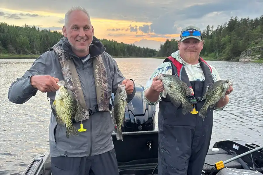 Two anglers holding walleye caught on Lake of the Woods