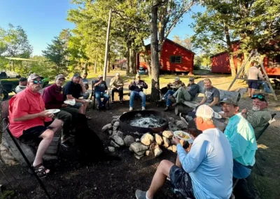 Guests gathered around the outdoor firepit at Grassy Narrows Lodge