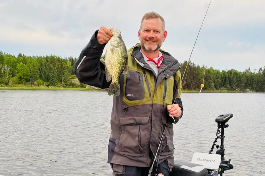 Lake of the Woods Crappie Fishing Angler holding a crappie caught while fishing Lake of the Woods