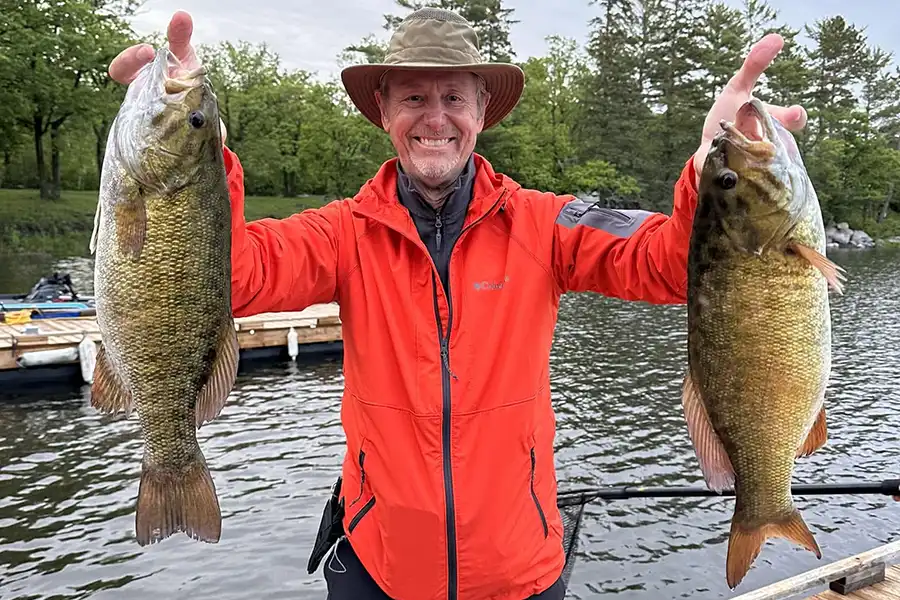 Angler holding a smallmouth bass caught while fishing Lake of the Woods