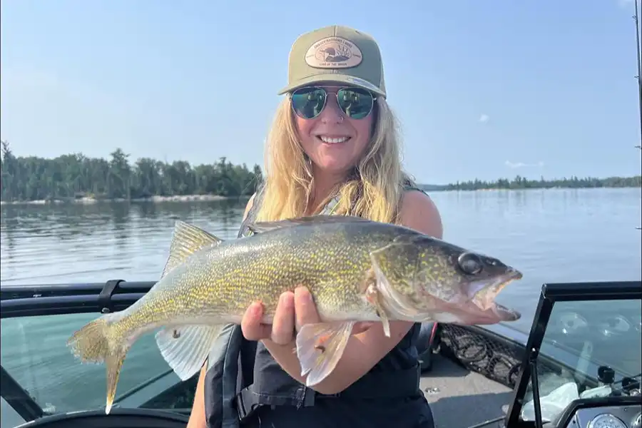 Angler holding a walleye during a fishing trip at Grassy Narrows Lodge